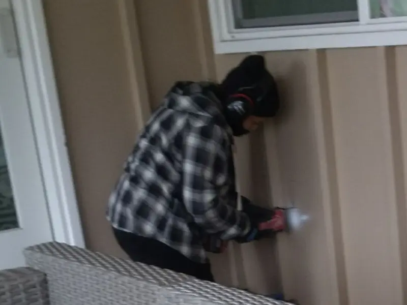 Professional electrician installing an exterior outlet in Greene
